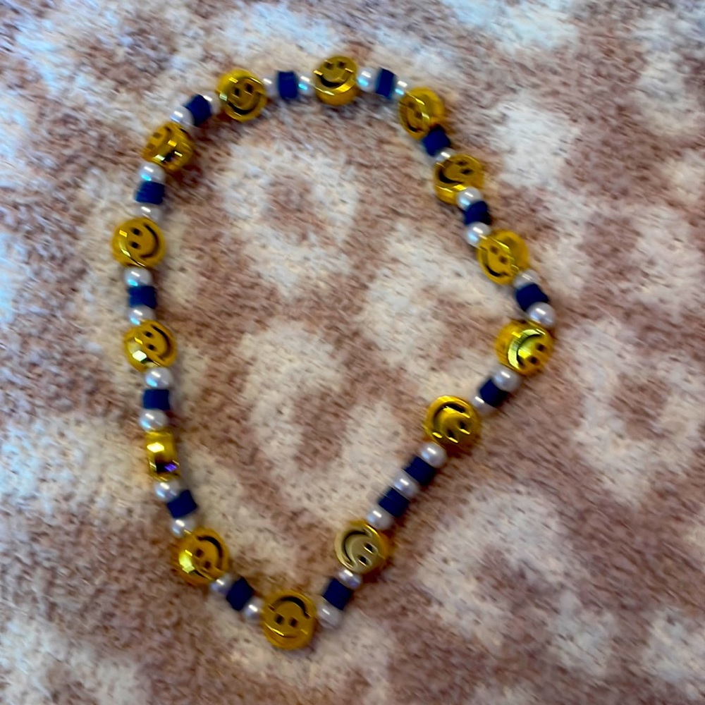 Blue Pearl necklace w/ smiley face charms on it
